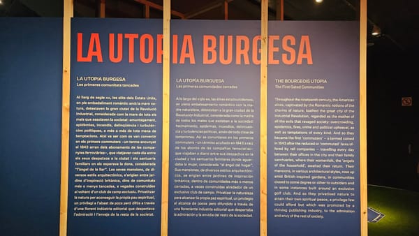 a blue panel with text and wood planks. the design alludes to blue prints and the frame of a house